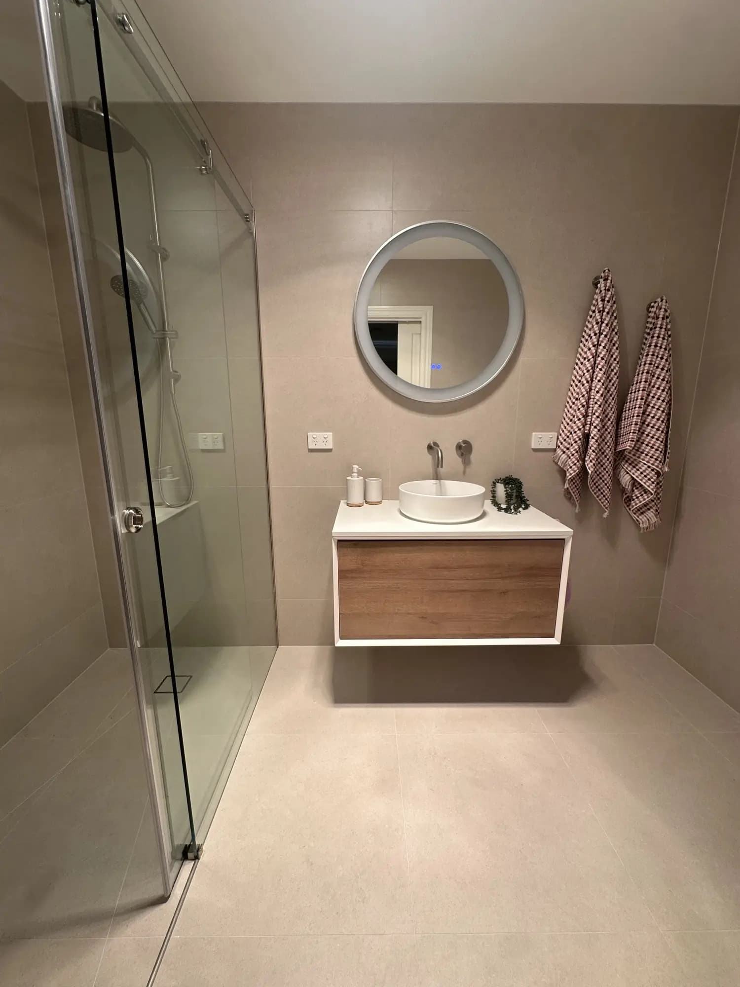 Modern bathroom renovation with floating vanity and heated towel rail in Melbourne home