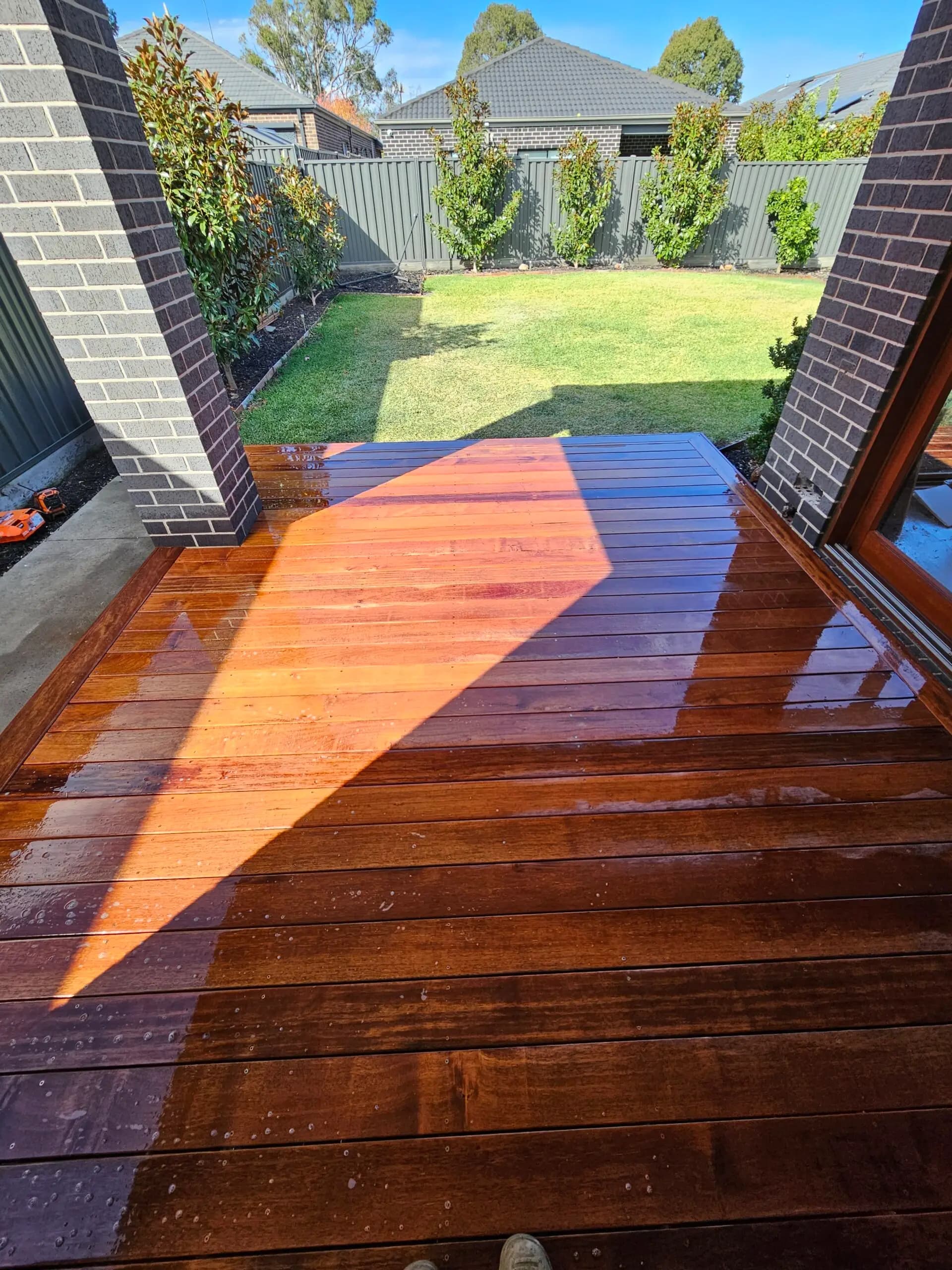 Covered outdoor entertaining area with pergola and ceiling fans in Melbourne